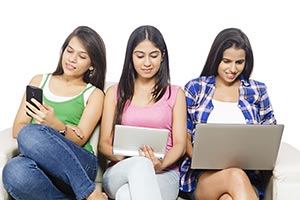 Young Girls Sitting Sofa Chatting