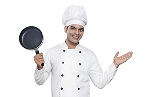Indain Chef Cook Peeking Behind Frying pan