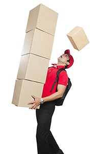 Deliveryman Holding Stack Parcels Dropping Some Th
