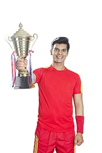 Indian Soccer Player Celebrates Championship Troph
