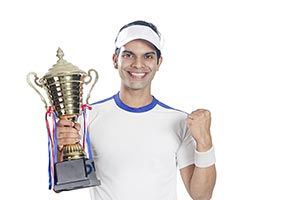 Tennis Player Celebrates Championship Trophy