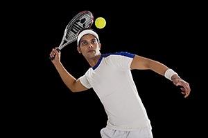 Indian Male Tennis Player Hitting Ball