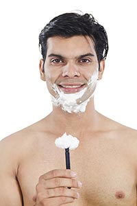 Happy Handsome Man Showing Razor Shaving