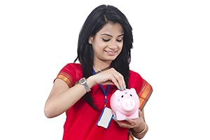 Businesswoman Inserting Money Piggybank