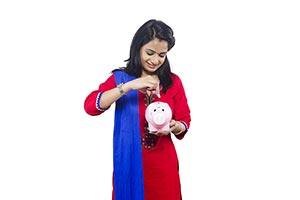 Woman Inserting Coin Piggy Bank