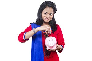 Woman Inserting Coin Piggybank