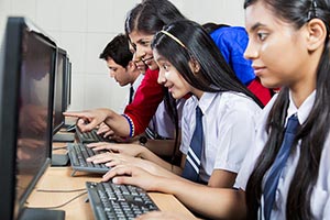 School Teacher Teaching Students Computer