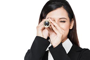 Businesswoman LookingThrough Telescope