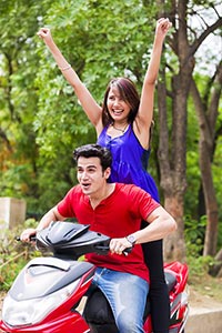 Young Couple Riding Scooter;