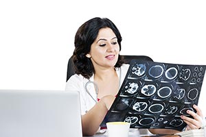 Woman Doctor Examining Xray Sitting Office