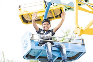 1 Person Only ; Amusement Park ; Arms Raised ; Boy