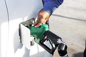 Worker filling car unleaded petrol pump Refuelling